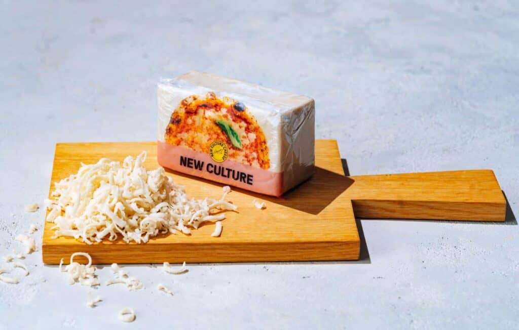 New Culture block of grating cheese on chopping board